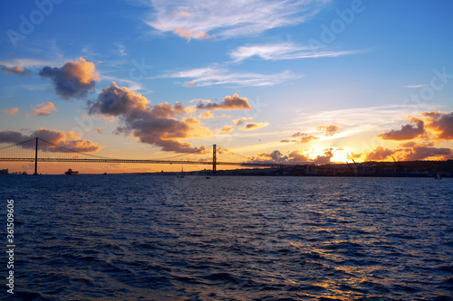View of Bridge in Lisbon in the Twilight . Scenery of Tagus River and Ponte 25 de Abril  photo