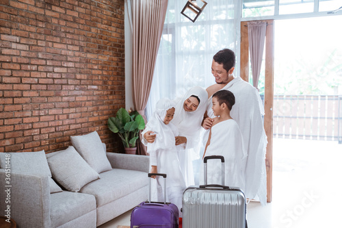 muslim umrah and hajj with family showing passport photo