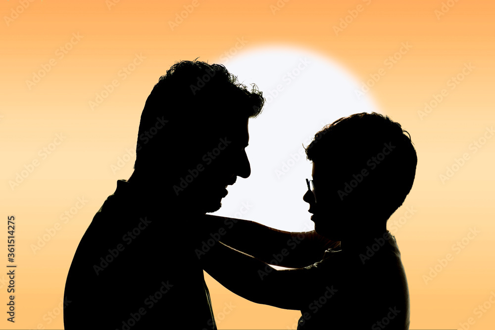 Silhouette of a happy father and son