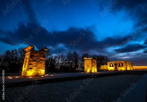The Temple of Debot in Madrid. a priceless gift from Egypt to Spain at twilight with golden walls and dark blue sky 