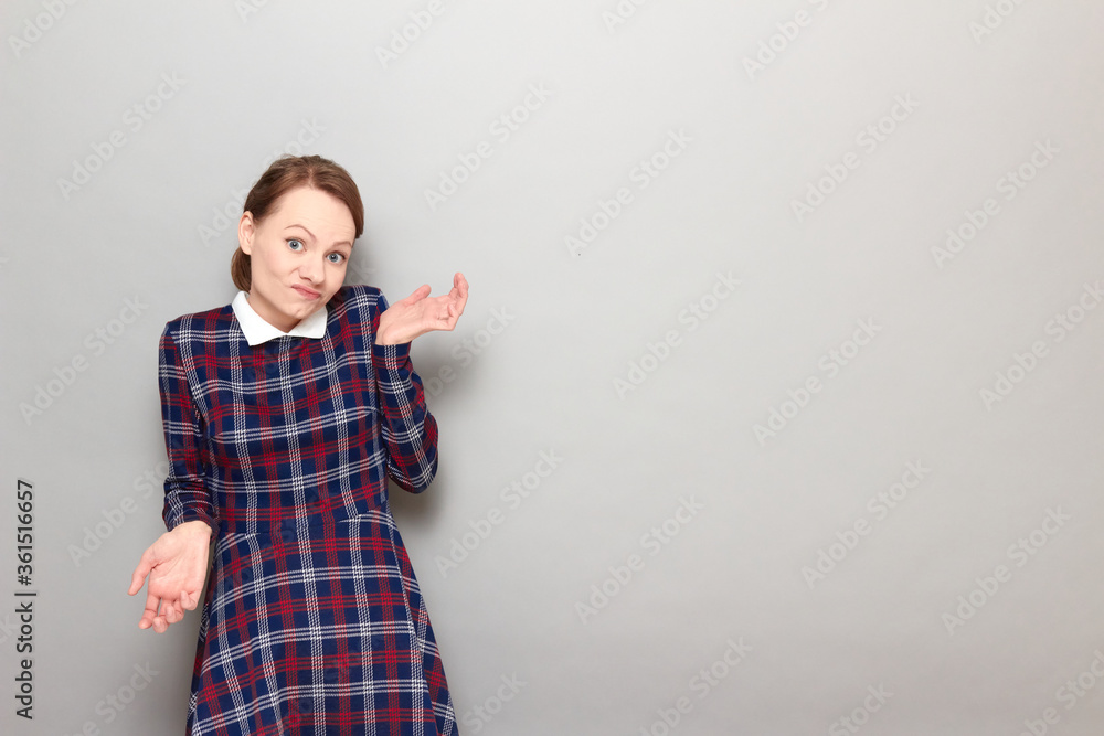 Portrait of funny confused girl waving hands and shrugging shoulders Portrait of funny confused girl waving hands and shrugging shoulders