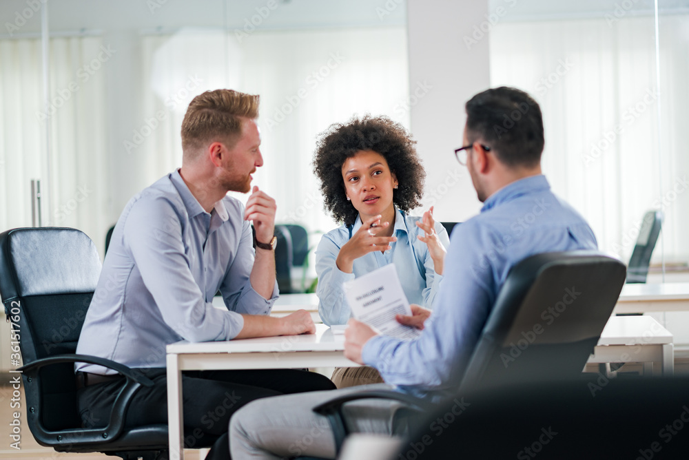 Business team discussing on a meeting. Business team discussing on a meeting.