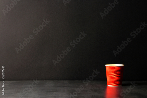 red corrugated paper coffee cup on black background