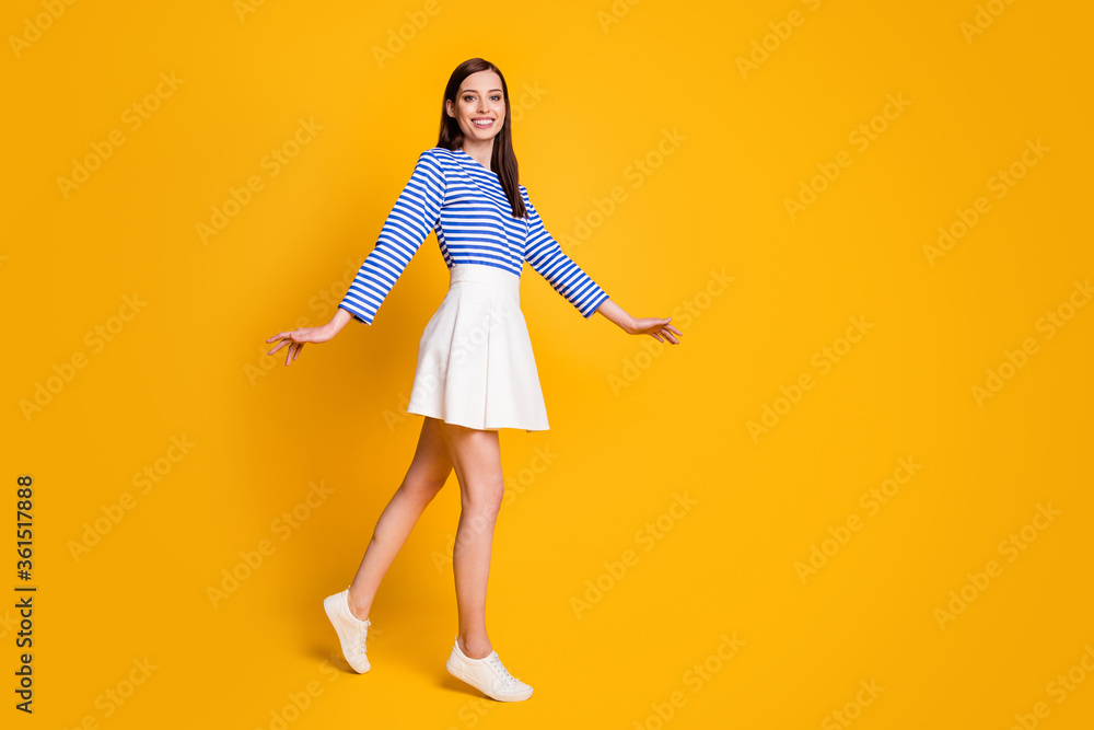 Full size profile side photo of friendly satisfied girl go walk spring free time weekend wear good look clothes sneakers isolated over shine color background Full size profile side photo of friendly satisfied girl go walk spring free time weekend wear good look clothes sneakers isolated over shine color background