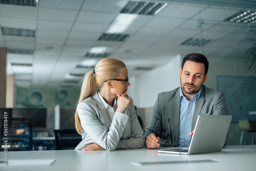 Two business people discussing work, portrait. Two business people discussing work, portrait.
