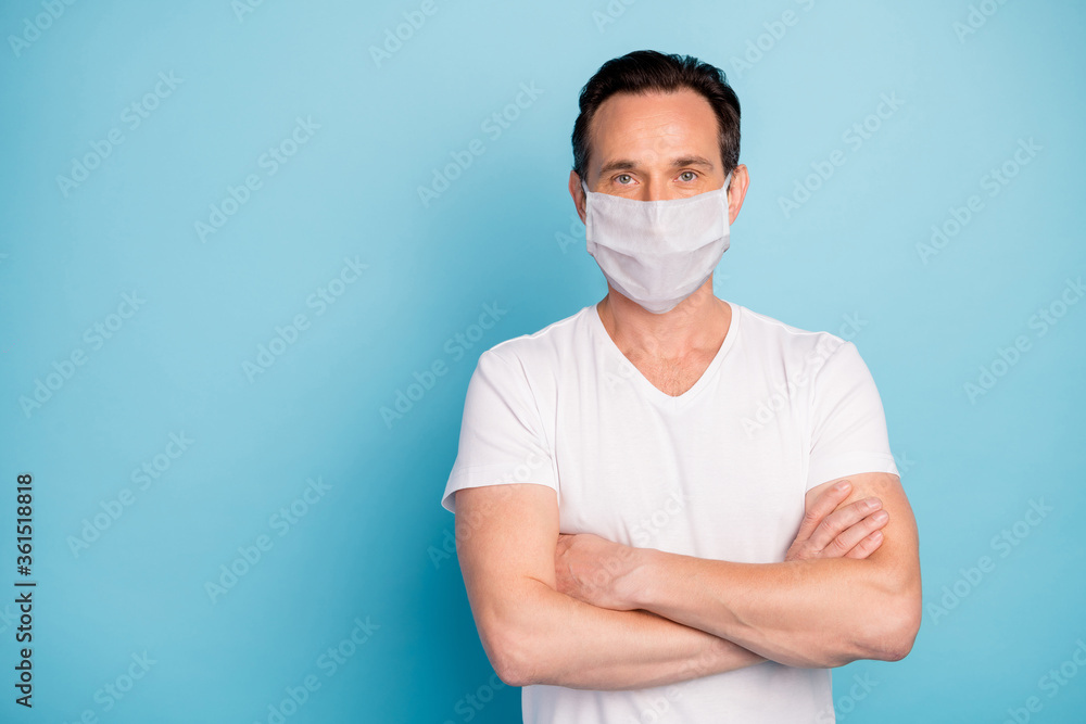 Portrait of his he nice pensive guy wearing safety gauze mask folded arms medicine healthcare stop pathogen viral pneumonia wuhan china isolated bright vivid shine vibrant blue color background