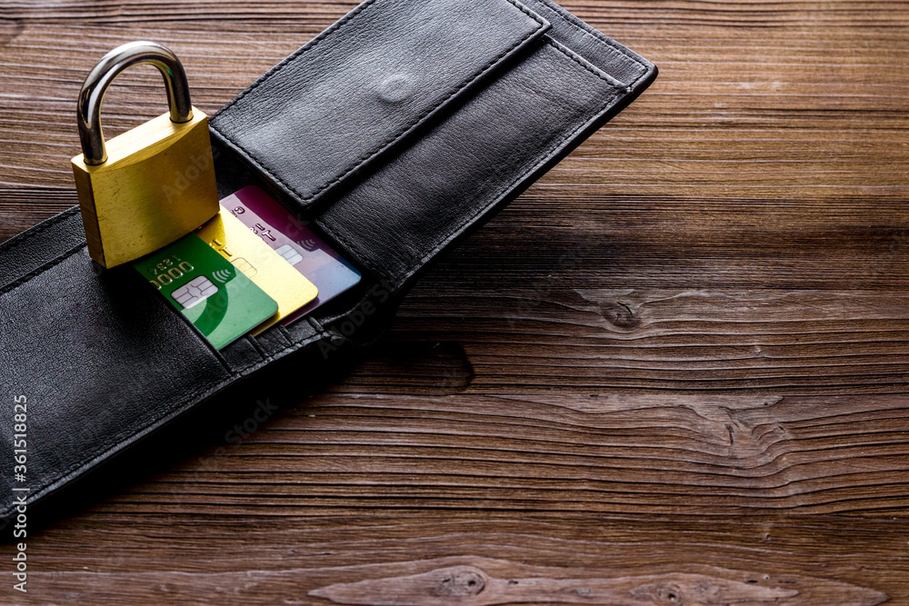 Credit card security concept with lock, wallet on wooden desk copy space Credit card security concept with lock, wallet on wooden desk copy space