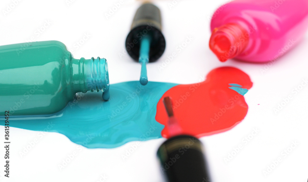 Fototapeta premium Spilled Nail Polish on White Background Pink and Green