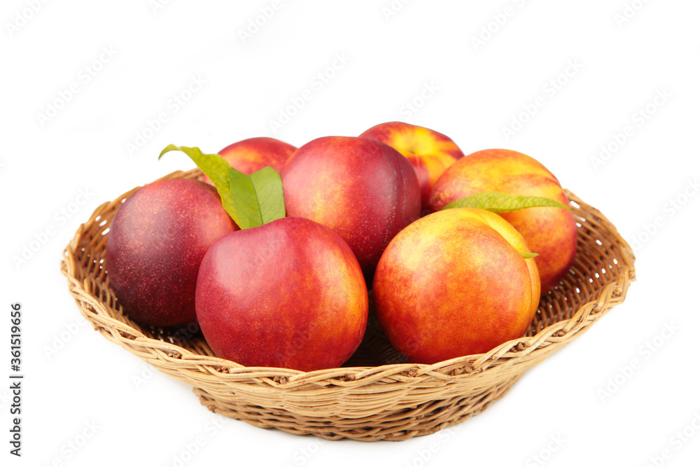Nectarines in a basket isolated on white background Nectarines in a basket isolated on white background