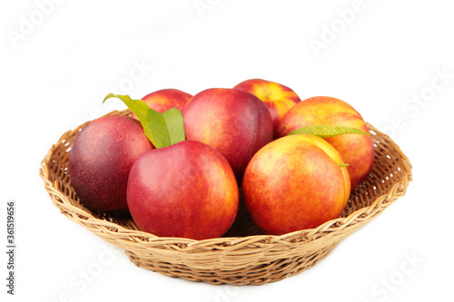 Nectarines in a basket isolated on white background