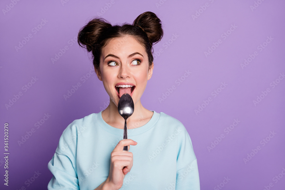 Close-up portrait of her she nice attractive hungry cheerful curious girl licking spoon fantasizing healthy regime ration isolated on violet purple lilac bright vivid shine vibrant color background Close-up portrait of her she nice attractive hungry cheerful curious girl licking spoon fantasizing healthy regime ration isolated on violet purple lilac bright vivid shine vibrant color background