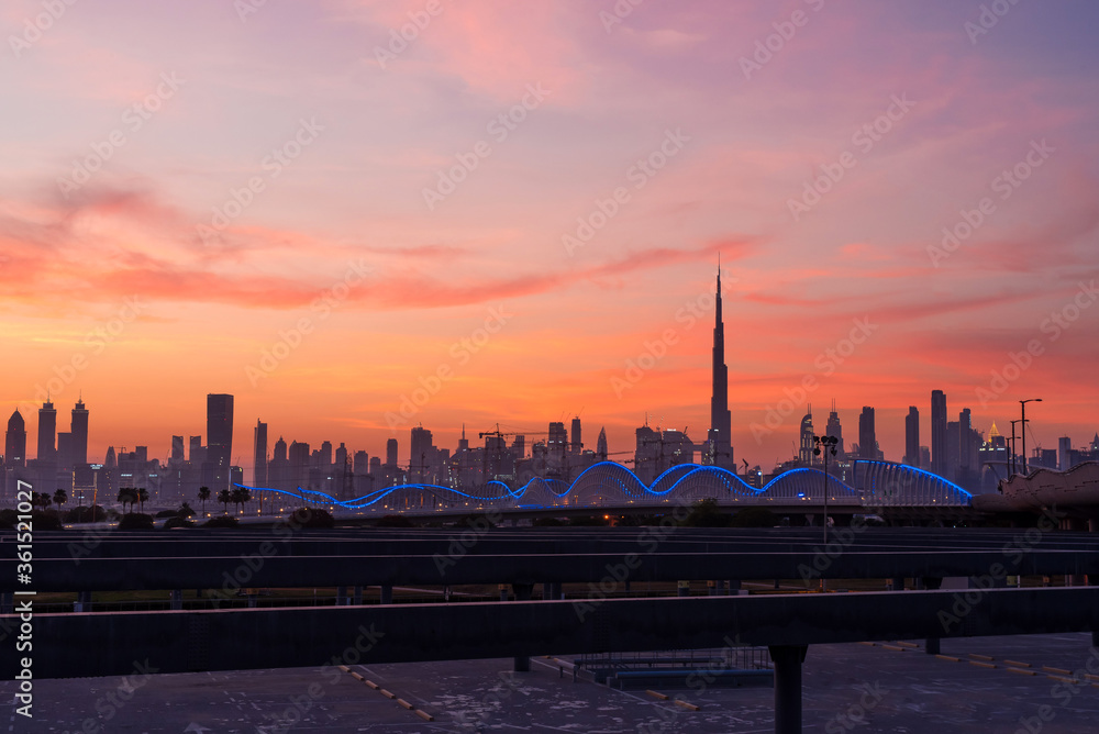 Beautiful sunset in Dubai. Night city scyline. Modern futuristic city lights. 