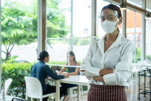 Portrait of restaurant staff wearing face shield, mask and glove in new normal conceptual