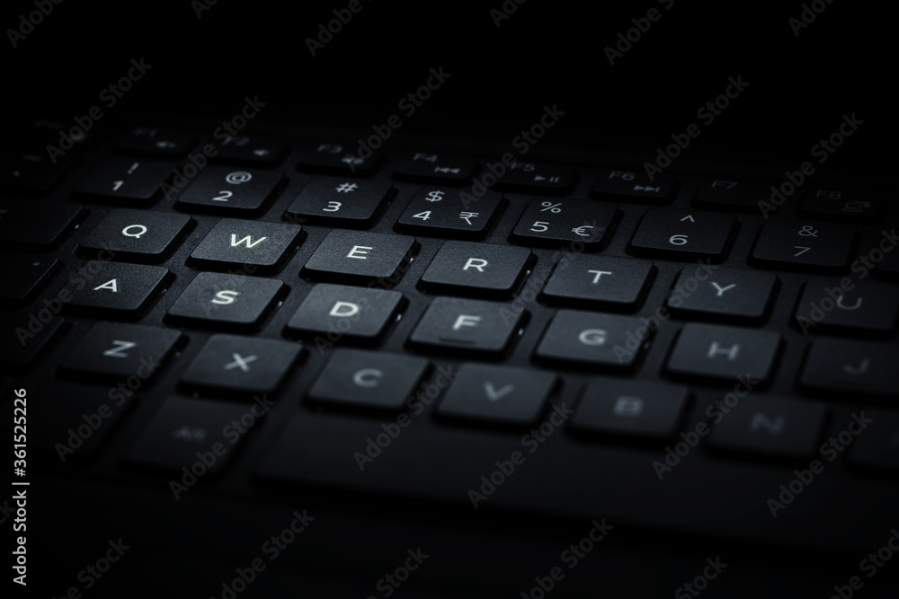 Closeup of black laptop QWERTY keyboard with light falling on keys. Closeup of black laptop QWERTY keyboard with light falling on keys.