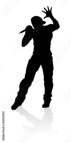 A singer pop, country music, rock star or hiphop rapper artist vocalist singing in silhouette