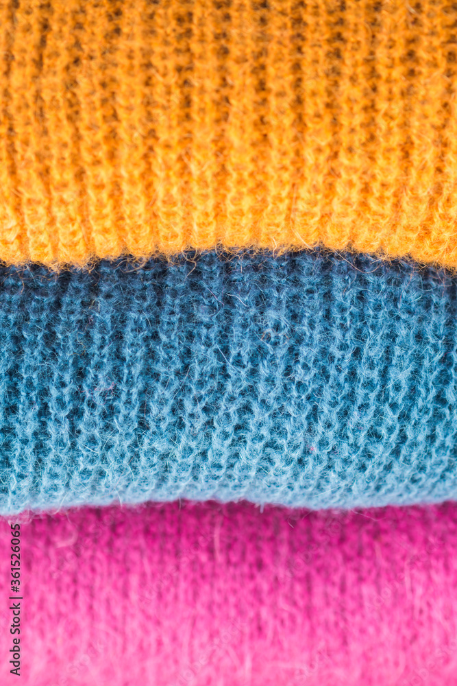 Pile of colorful woolen sweaters. Fall, winter fashion colors Pile of colorful woolen sweaters. Fall, winter fashion colors