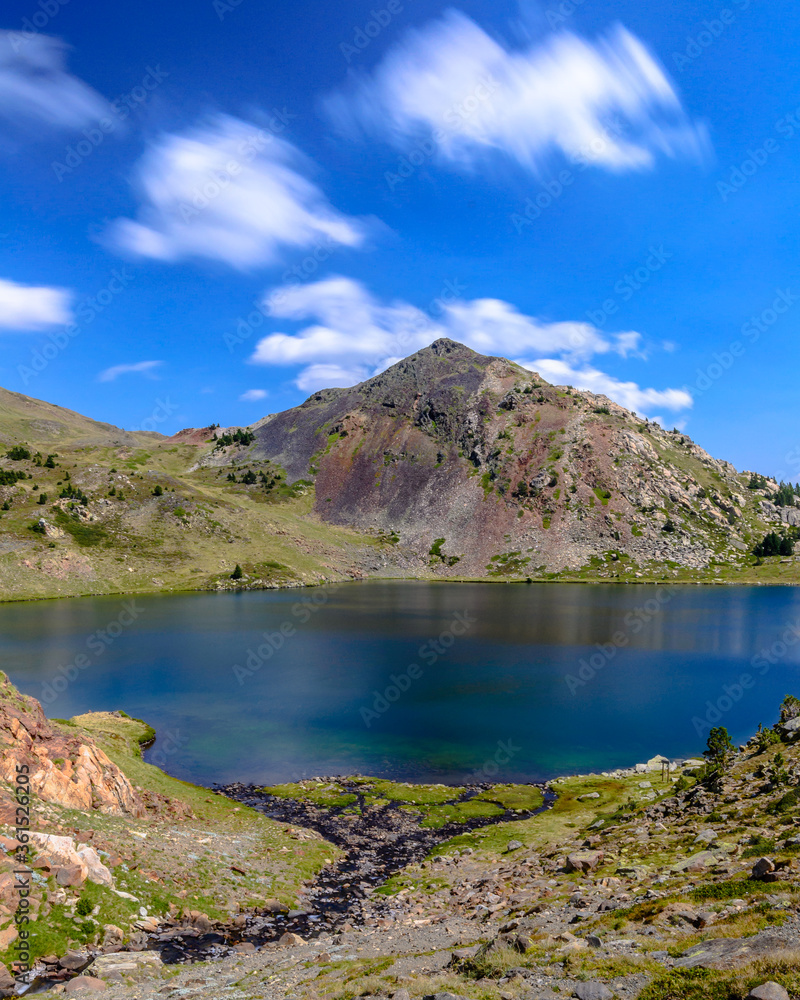 A blue water lake in the Pyrenees Mountains. (Capcir, France, the route of the Bouillouses Lakes, near the Massif of Carlit)