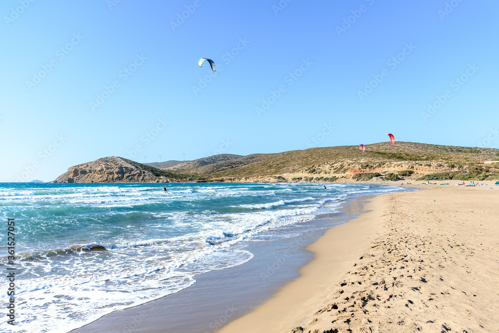 Prasonisi beach with kitesurfers surfing in waves (Rhodes, Greece)