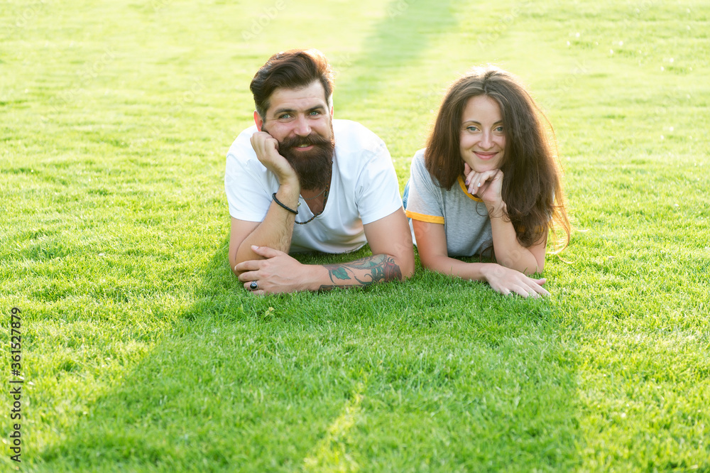 We are dating. Happy couple relax on green grass. Couple in love summer outdoors. Sexy couple in casual wear. Couple of sensual girl and hipster. Boyfriend and girlfriend. Love and romance We are dating. Happy couple relax on green grass. Couple in love summer outdoors. Sexy couple in casual wear. Couple of sensual girl and hipster. Boyfriend and girlfriend. Love and romance