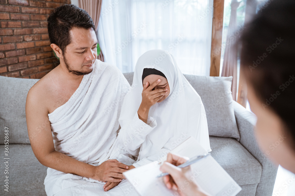 sad muslim woman and husband being cancel to travel for hajj sad muslim woman and husband being cancel to travel for hajj