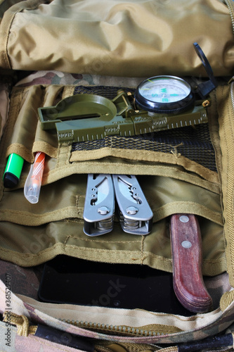 Compass, knife and multitool in a backpack