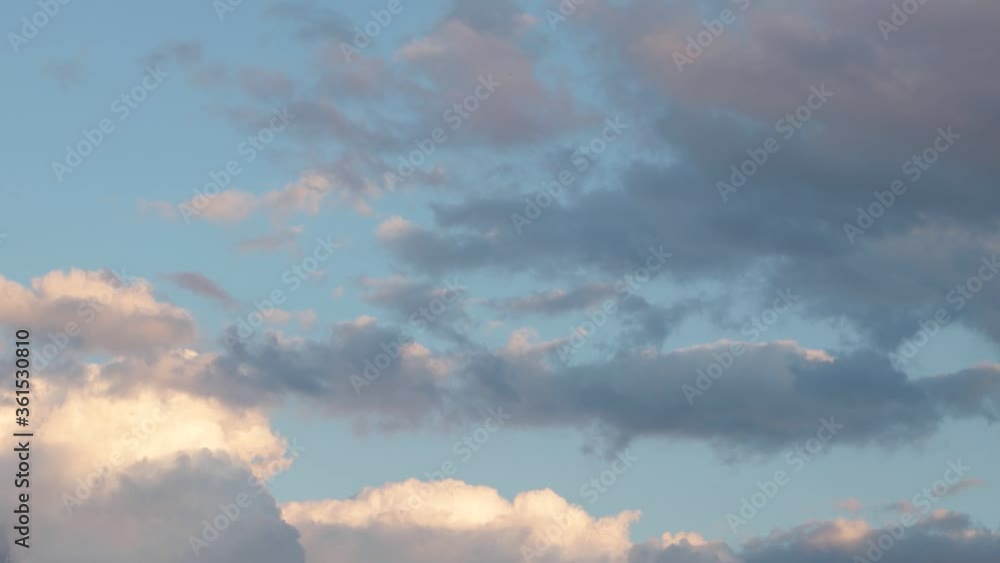 Gray-blue and pink clouds float through the sky at sunset, time lapse Gray-blue and pink clouds float through the sky at sunset, time lapse