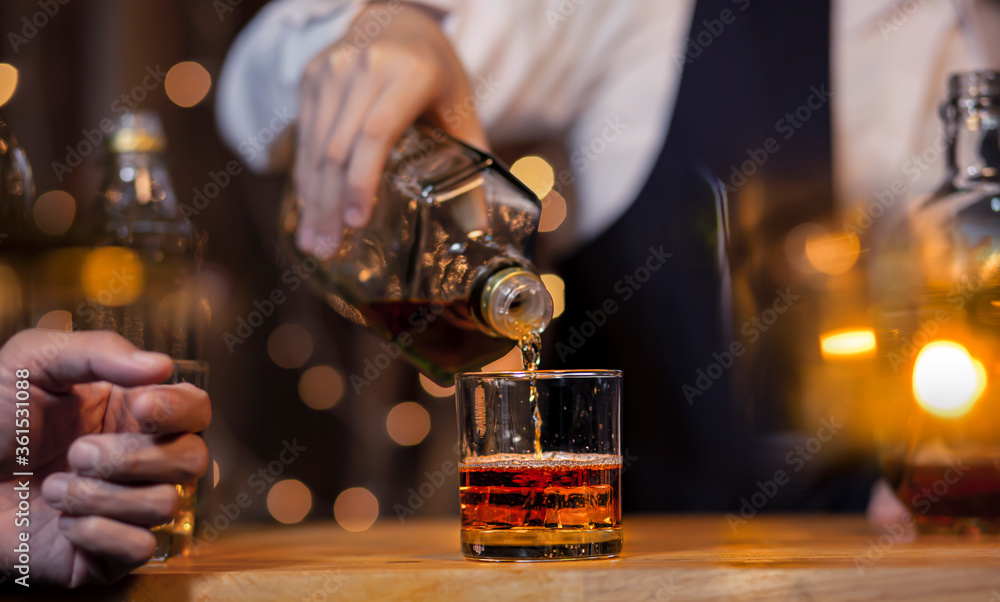 Bartender Serve Whiskey on wood bar Bartender Serve Whiskey on wood bar