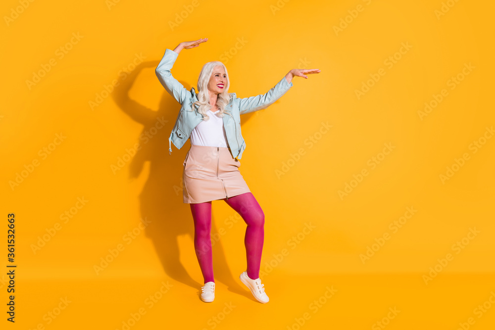 Full length body size of her she nice-looking attractive pretty fashionable cheerful cheery gray-haired woman having fun time dancing isolated on bright vivid shine vibrant yellow color background Full length body size of her she nice-looking attractive pretty fashionable cheerful cheery gray-haired woman having fun time dancing isolated on bright vivid shine vibrant yellow color background