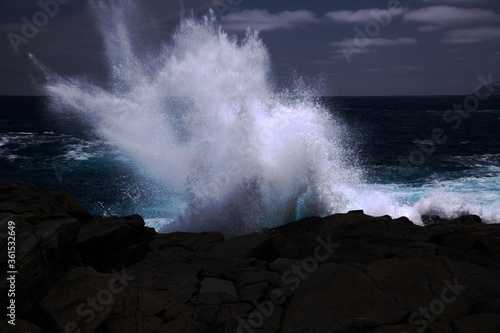 North coast of Gran Canaria, lava fields of Banaderos area, grey textured lava from eruption of Montana de Arucas, breaking waves photo