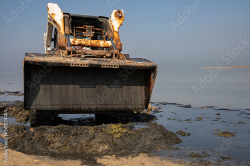 bobcat, works to clean the beach, Skid loader