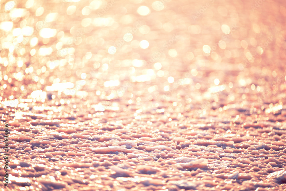 Salt on a pink salt lake and sparkling bokeh. Abstract textural photo. Natural pink salt. Salt on a pink salt lake and sparkling bokeh. Abstract textural photo. Natural pink salt.