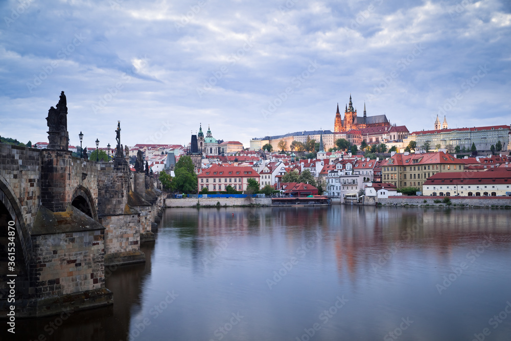 Side view of Charles bridge and illuminated Prague castle just after sunset