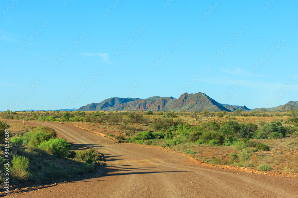 A empty dirt road in the  South Flinders Ranges in South Australia against a clear blue sky
