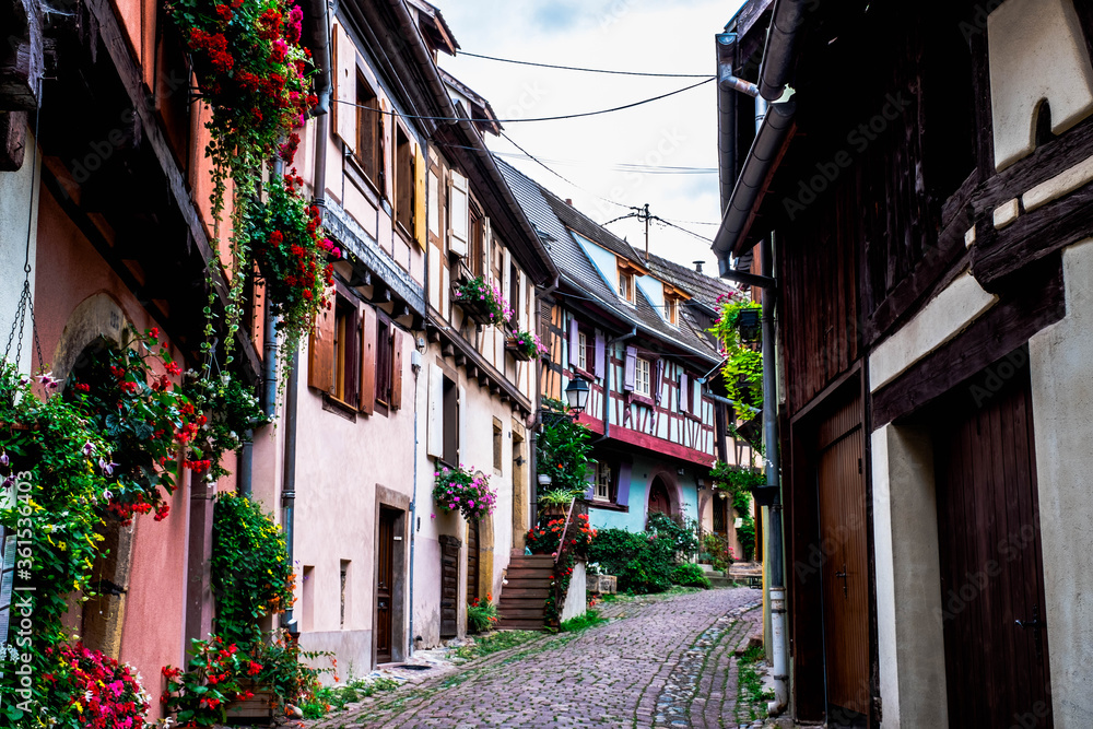 Streets of Eguisheim in Alsace, France, with traditional houses and colored facades