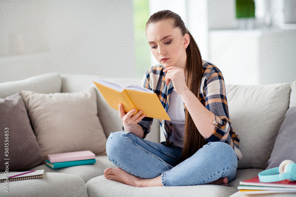 Profile photo of young serious lady student hold book diary hands sit sofa legs crossed reading interesting historic novel resting home remote social distance freelancer quarantine indoors Profile photo of young serious lady student hold book diary hands sit sofa legs crossed reading interesting historic novel resting home remote social distance freelancer quarantine indoors
