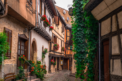 Streets of Eguisheim in Alsace, France, with traditional houses and colored facades © joan