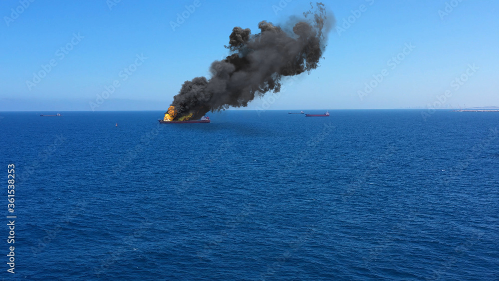Foto de Cargo ship burning on fire with large scale smokeAerial Aerial