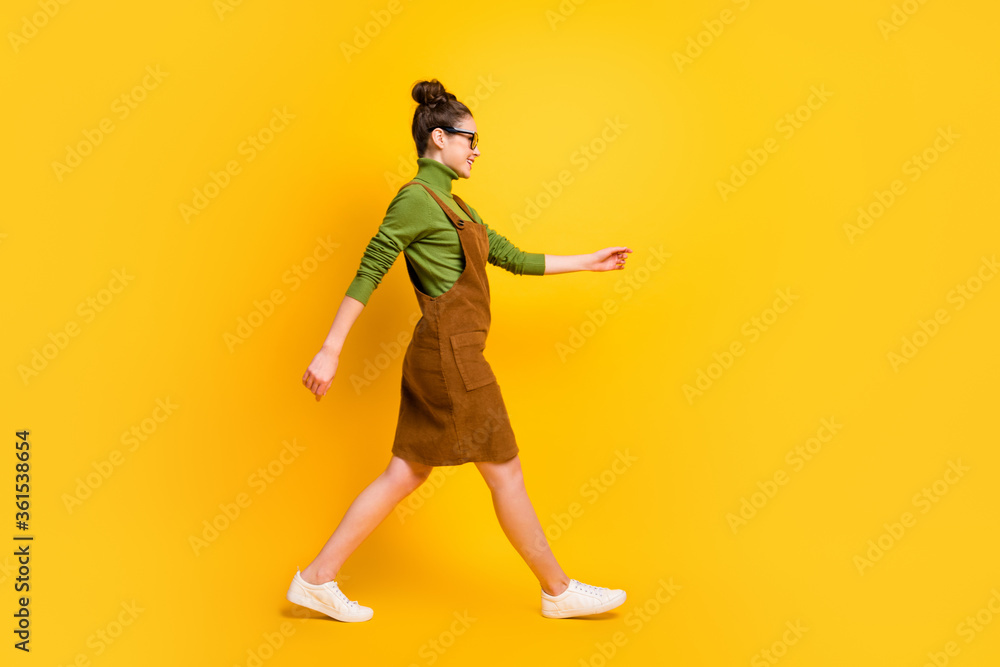Full length body size profile side view of her she attractive cheerful girl wearing casual going back to school autumn fall 1 September isolated bright vivid shine vibrant yellow color background