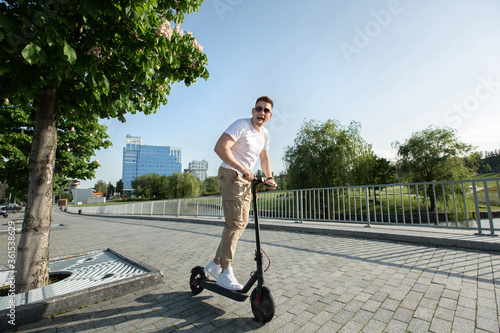 Man rides an electric scooter around the city