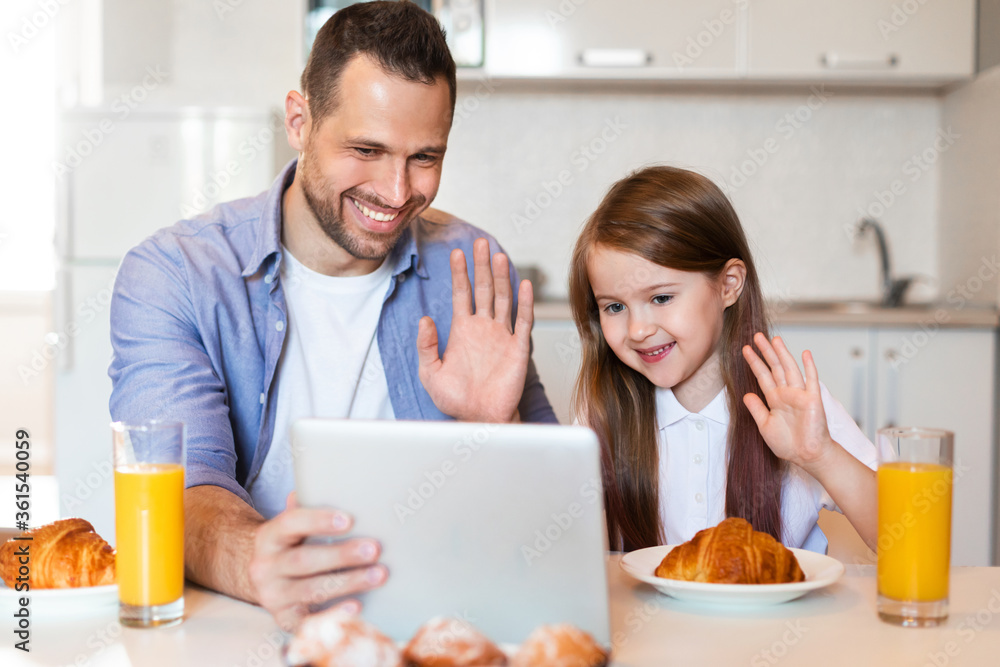 Father And Daughter Making Video Call Having Breakfast At Home