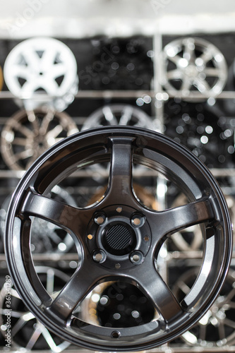 Wheel disks closeup, sale of disks in the showroom. Chrome wheels modern exclusive design..
