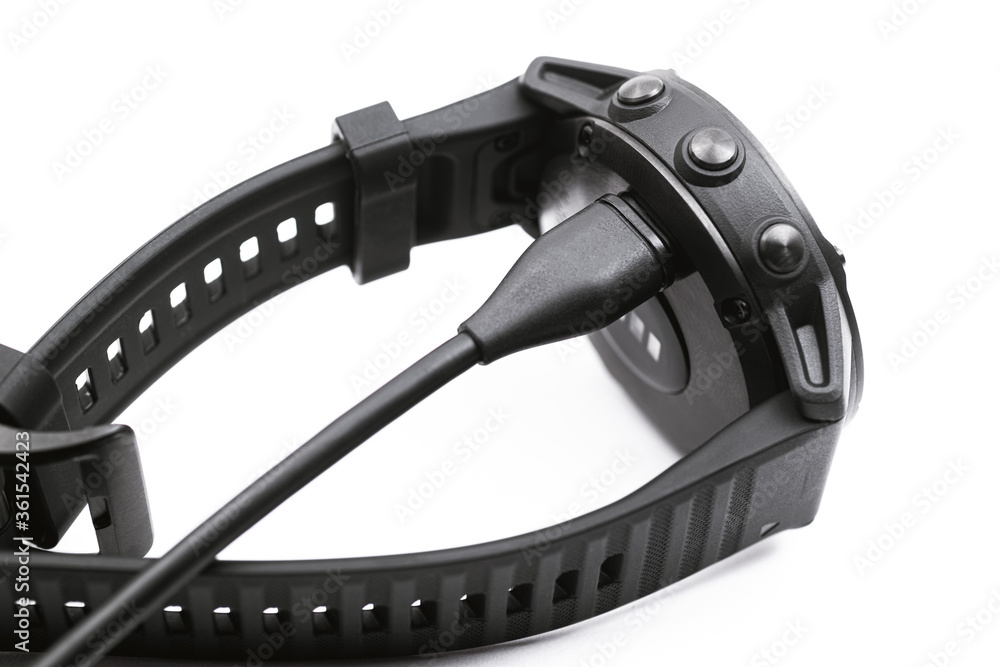 Obraz premium Smart watch charge concept. Charging fitness tracker isolated on white background