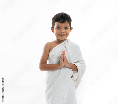 kid boy greeting smiling to camera isolated over white background
