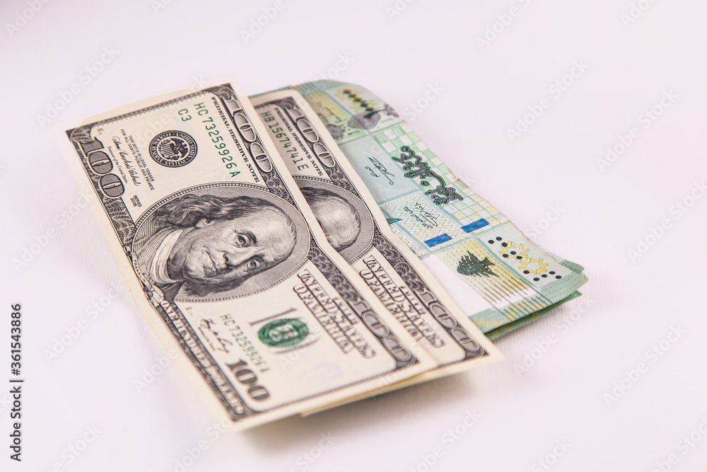 Hundreds of Libanese Pounds and US Dollars Currency Papers isolated on White Background Hundreds of Libanese Pounds and US Dollars Currency Papers isolated on White Background