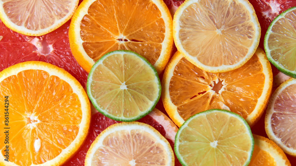 Beautiful fresh sliced mixed citrus fruits like background. Concept of healthy eating, detox, diet. Top view.