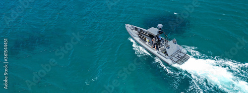 Aerial drone ultra wide photo of rigid inflatable speed boat cruising in deep blue Aegean sea, Greece © aerial-drone