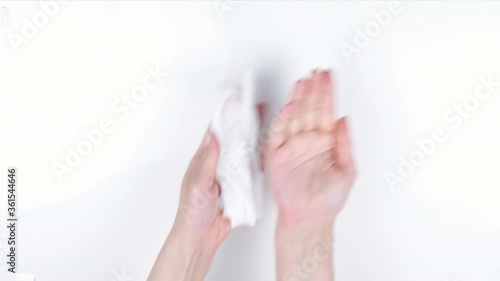 Cleaning hands with antibacterial wet wipe.