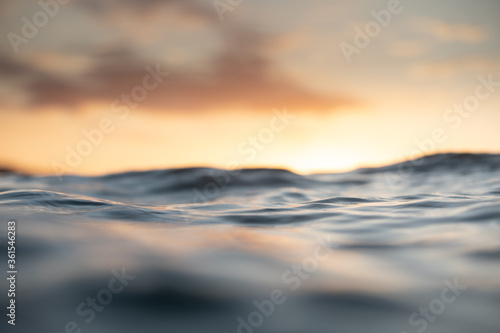 Waves in the ocean at sunrise or sunset