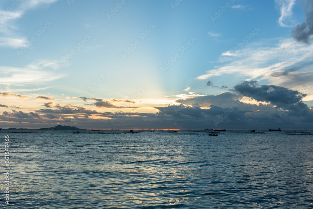 Beautiful sunset in Thailand pattaya ocean sea view with beach sand pier boat sun blue sky in summer holiday vacation Beautiful sunset in Thailand pattaya ocean sea view with beach sand pier boat sun blue sky in summer holiday vacation