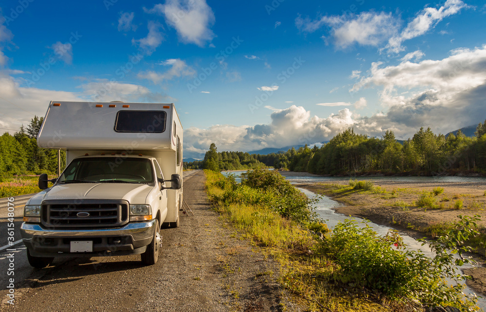 Campervan parked beside the Kitimat River in the evening sun.